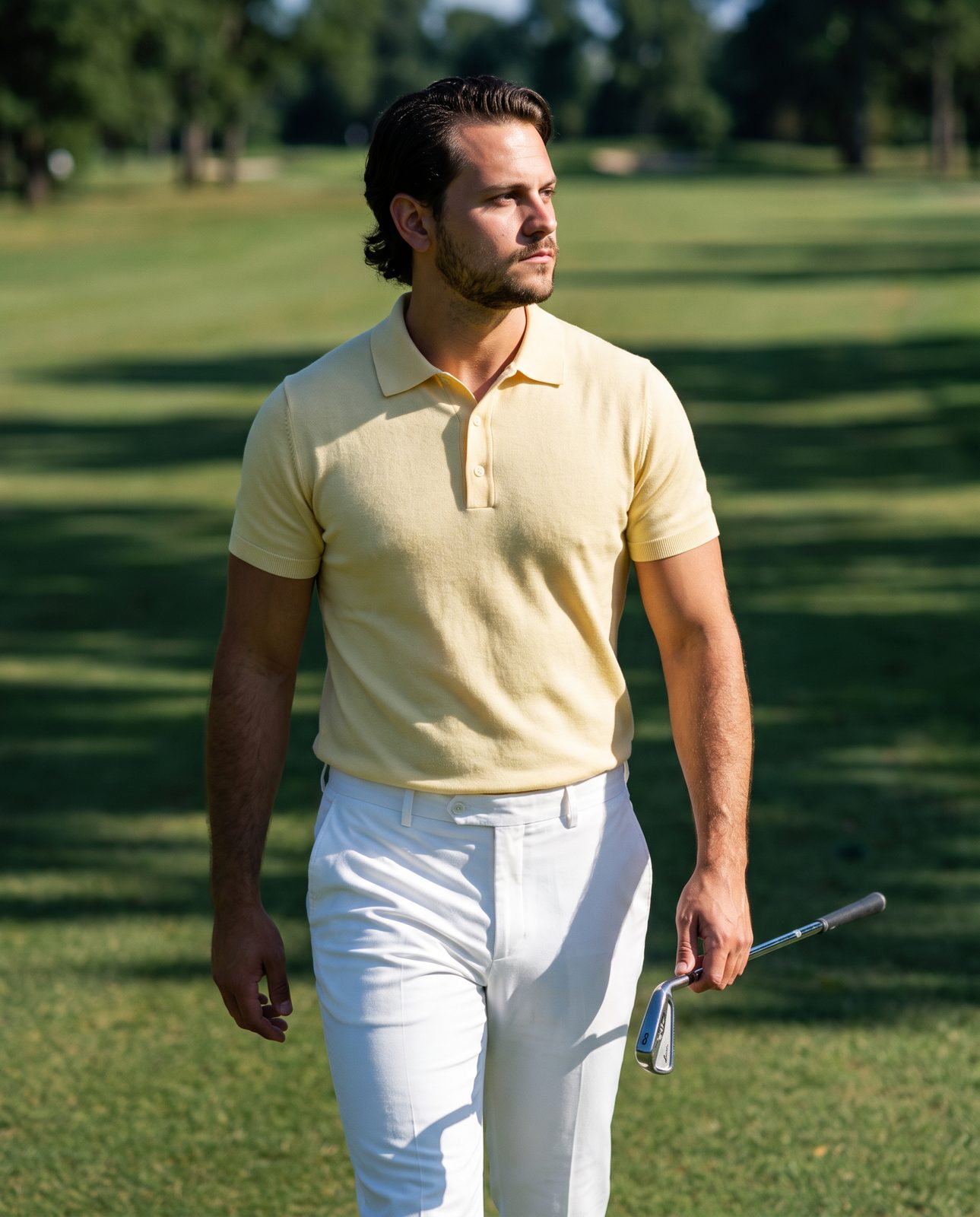 Golfer in a butter yellow wool polo walking the fairway